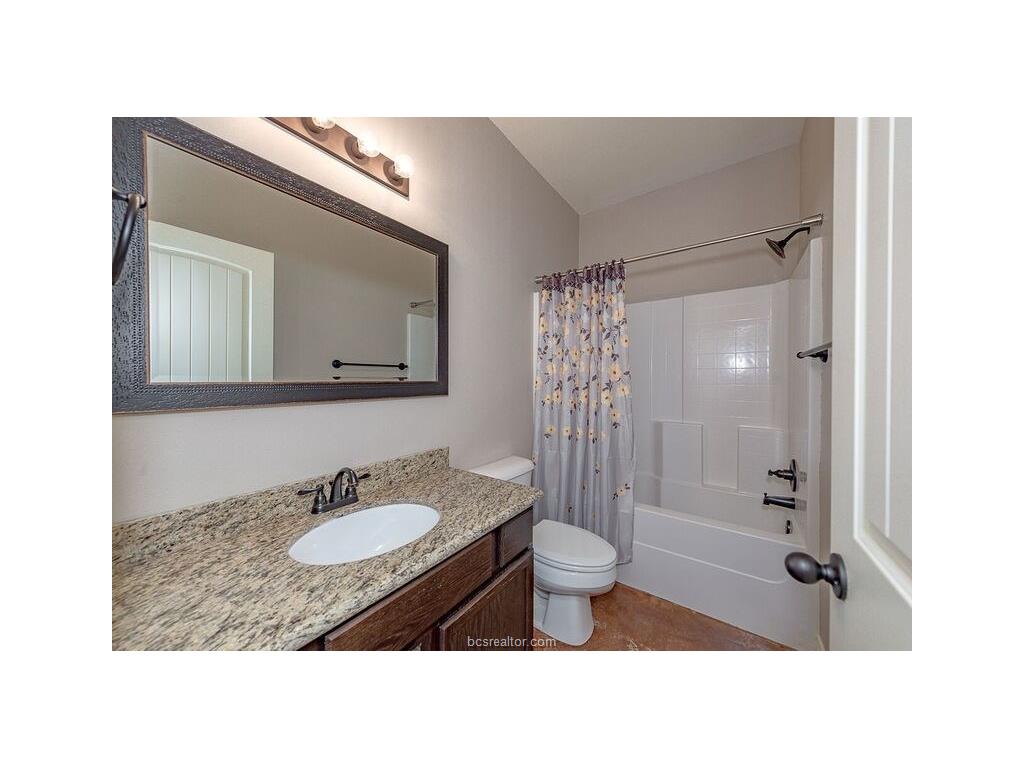 129 Watson Lane Bryan, TX 77801 - Photo 11 of 20 a bathroom with a sink toilet a mirror and shower