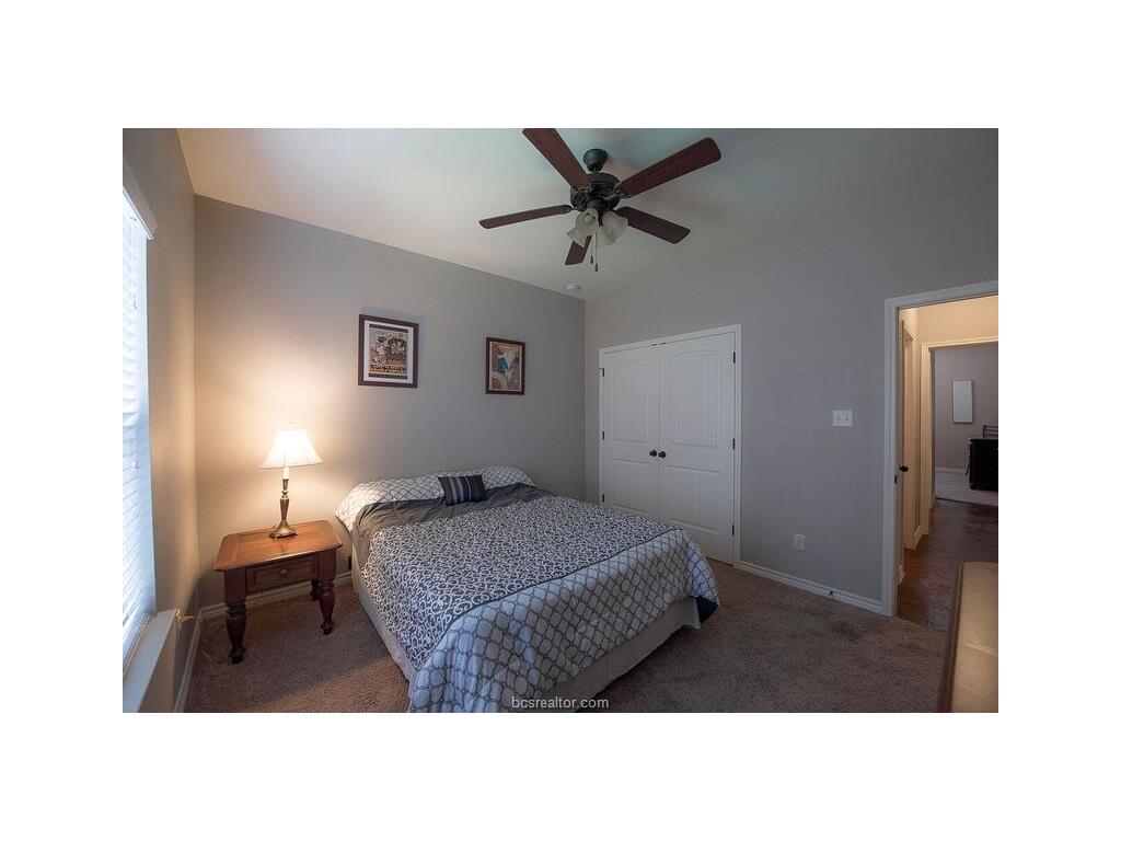 129 Watson Lane Bryan, TX 77801 - Photo 12 of 20 a bedroom with a bed and a painting