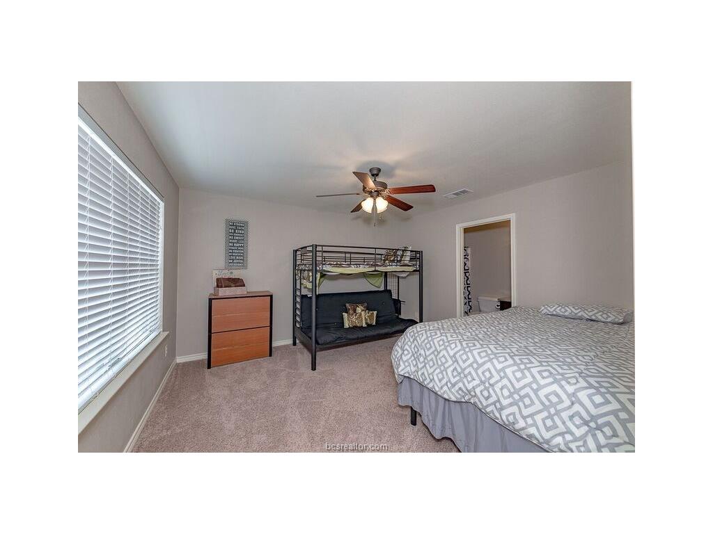 129 Watson Lane Bryan, TX 77801 - Photo 17 of 20 a living room with furniture a fireplace and a chandelier