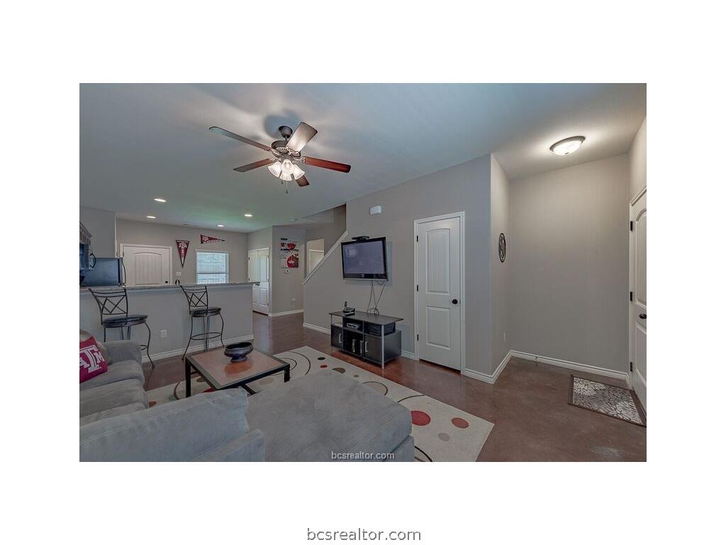 129 Watson Lane Bryan, TX 77801 - Photo 3 of 20 a living room with stainless steel appliances kitchen island furniture and a chandelier