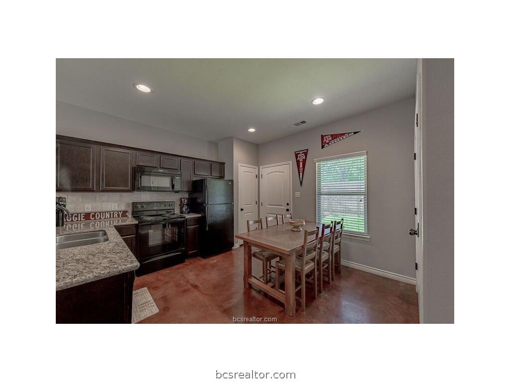 129 Watson Lane Bryan, TX 77801 - Photo 4 of 20 a living room with stainless steel appliances kitchen island granite countertop a sink a dining table and chairs