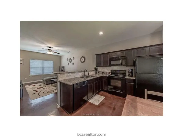 a kitchen with a refrigerator and a sink