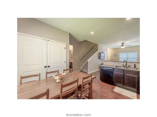 a kitchen with a table and chairs
