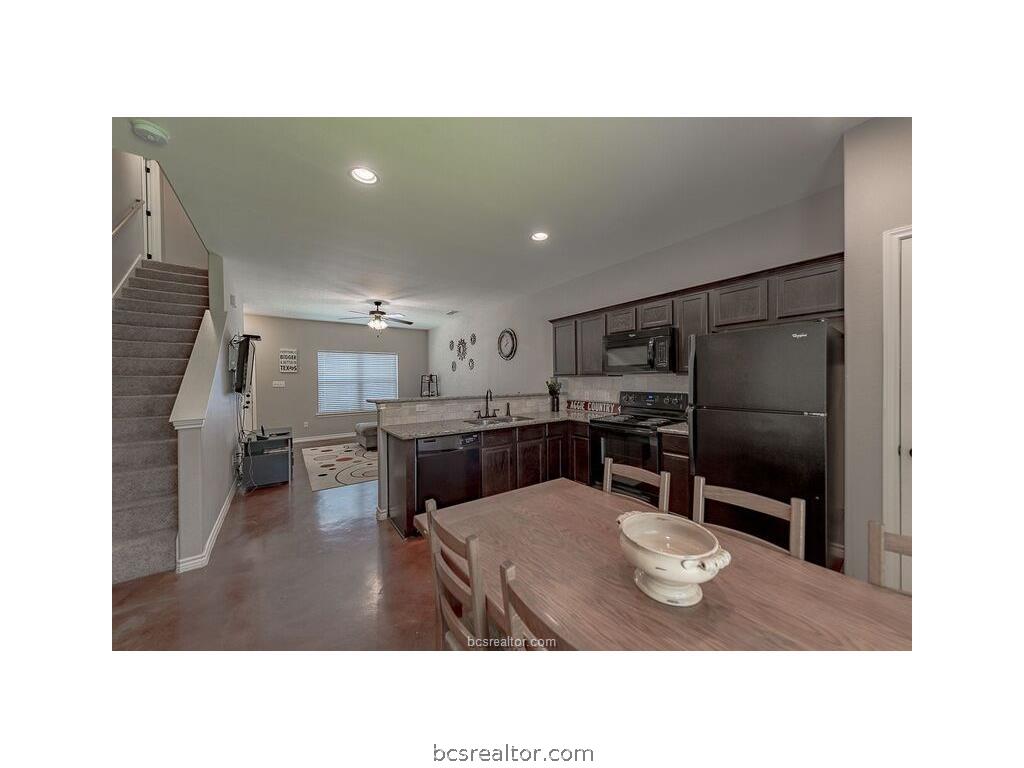 129 Watson Lane Bryan, TX 77801 - Photo 7 of 20 a kitchen with a table and chairs