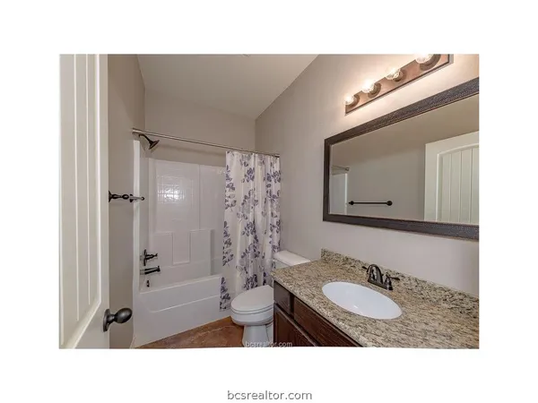 a bathroom with a sink toilet a mirror and shower