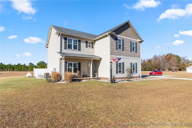 a view of an house with backyard and ocean view
