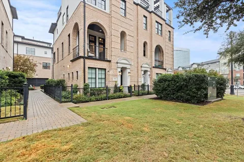 a front view of a house with yard and trees
