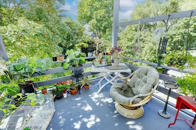 a view of a chair and tables in the back yard