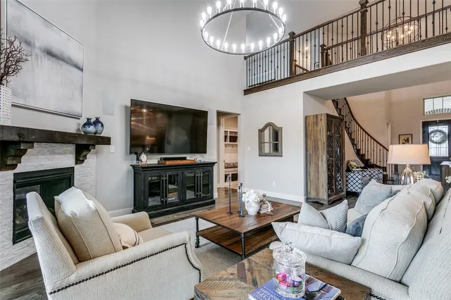 a living room with furniture a flat screen tv and a fireplace