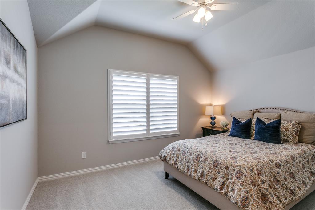 1801 Wichita Drive Prosper, TX 75078 - Photo 33 of 36 a bedroom with a bed and a chandelier