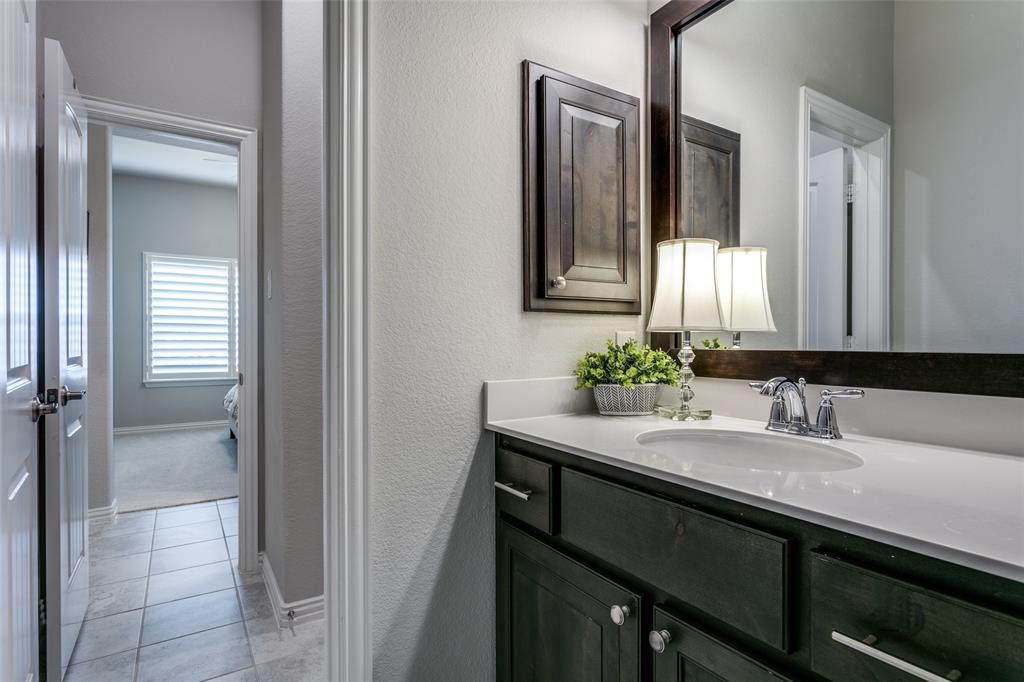 1801 Wichita Drive Prosper, TX 75078 - Photo 34 of 36 a bathroom with a sink and a mirror