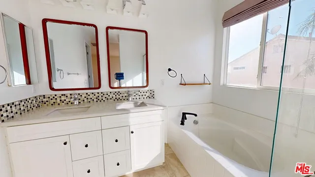 a bathroom with a bathtub and a shower