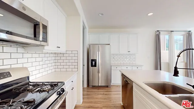 a kitchen with a stove and a refrigerator