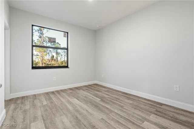 a bathroom with a granite countertop sink toilet and a mirror