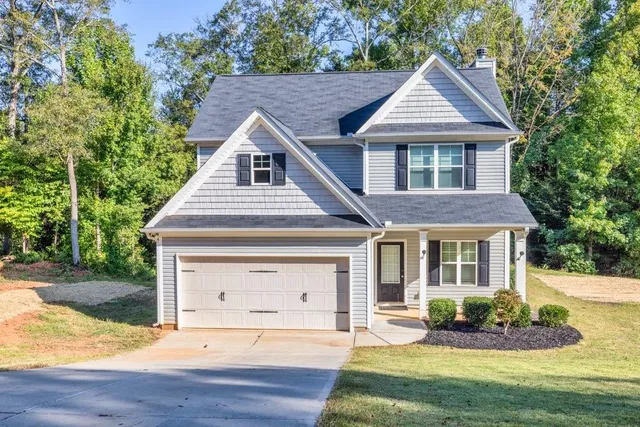 a front view of a house with a yard