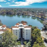 an aerial view of a house with outdoor space and lake view in back
