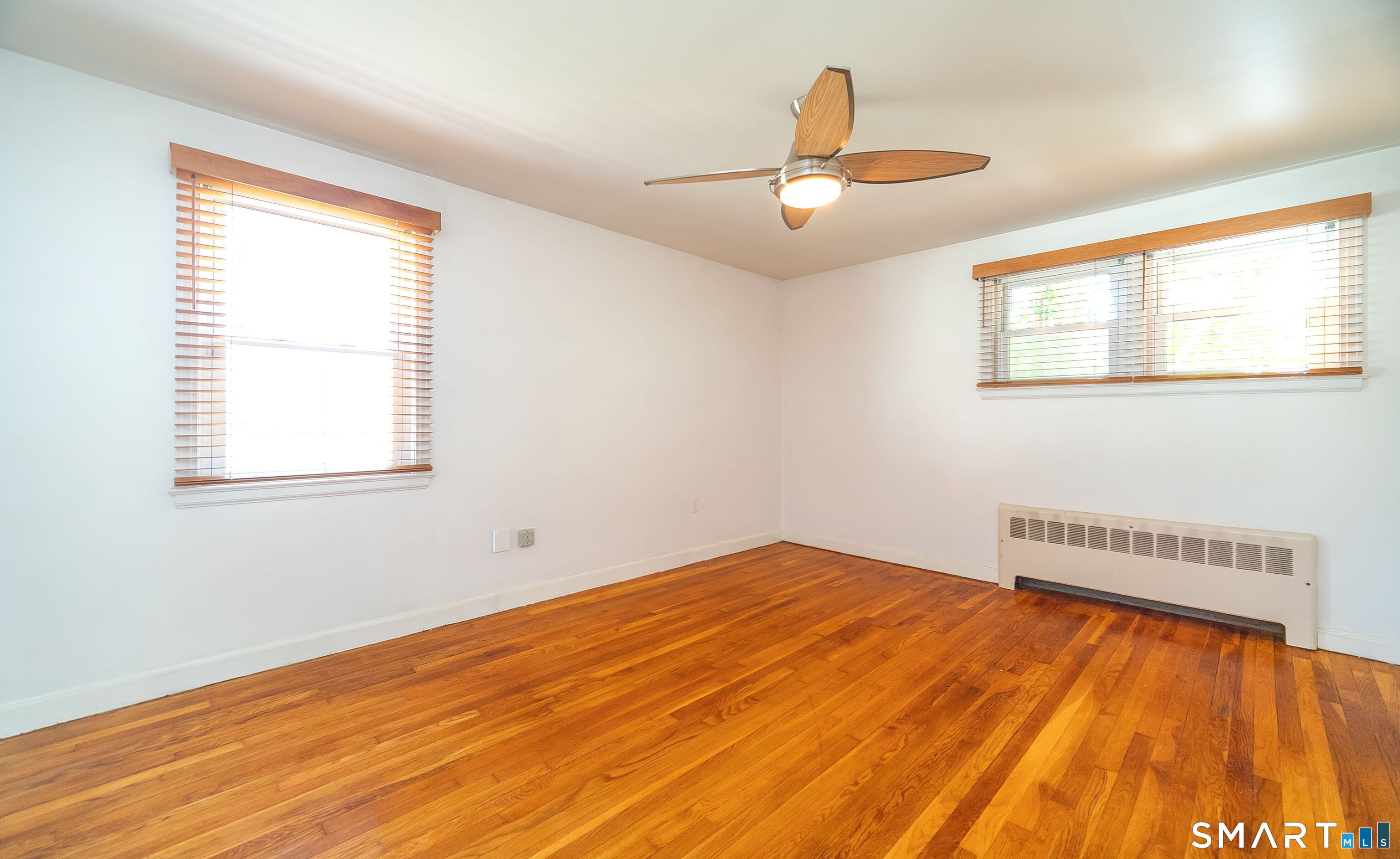 16 Featherbed Lane Branford, CT 06405 - Photo 14 of 40 a view of an empty room with wooden floor and a window