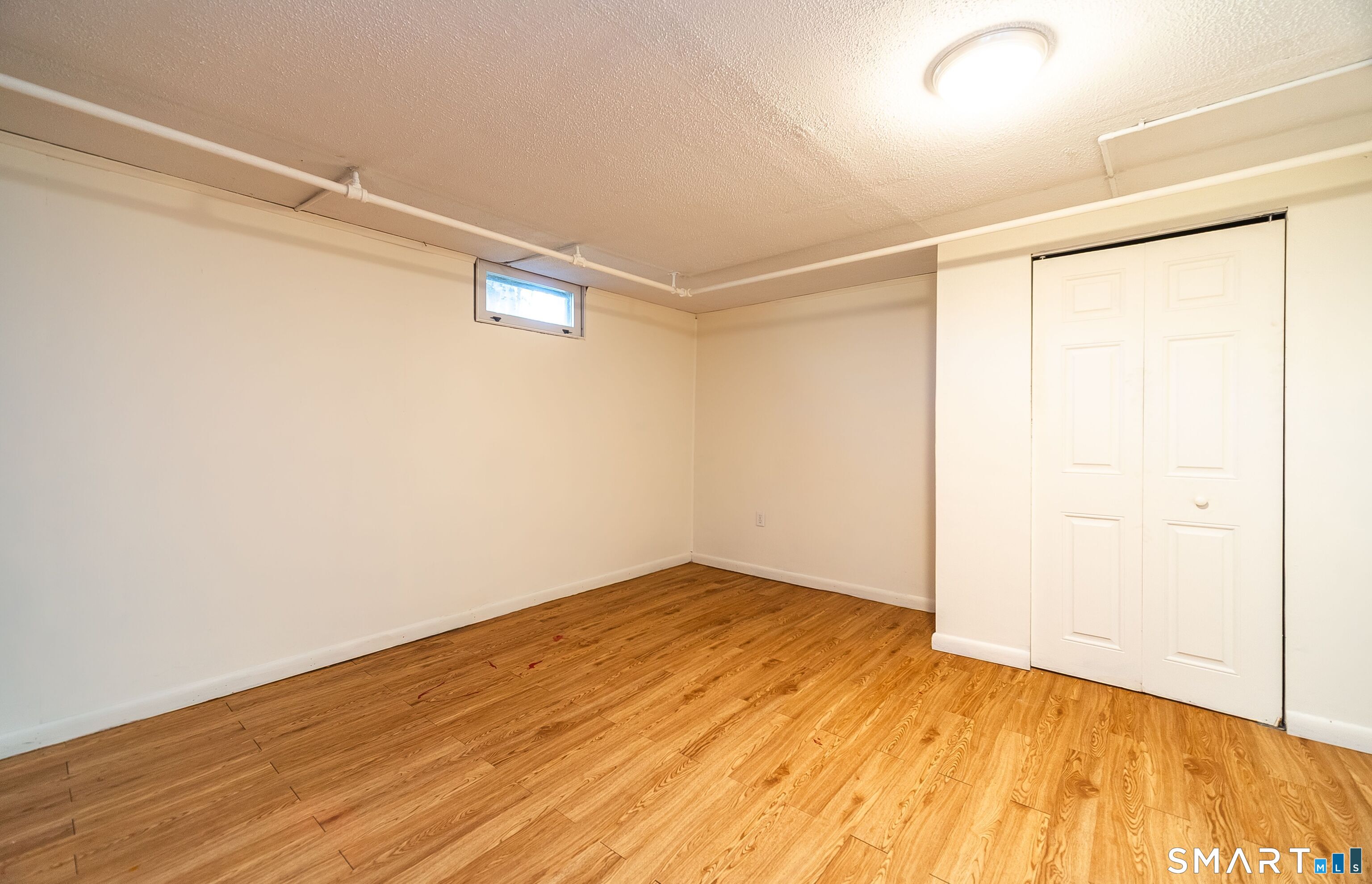 16 Featherbed Lane Branford, CT 06405 - Photo 19 of 40 an empty room with wooden floor and windows