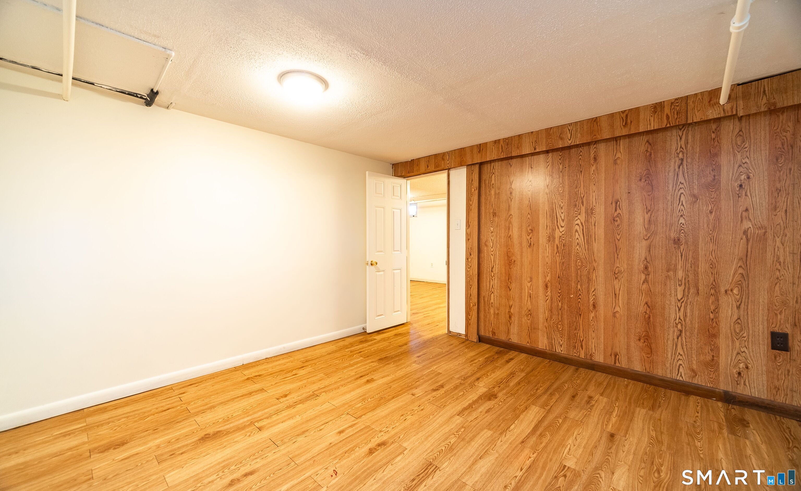 16 Featherbed Lane Branford, CT 06405 - Photo 21 of 40 a view of a room with wooden floor and brick walls