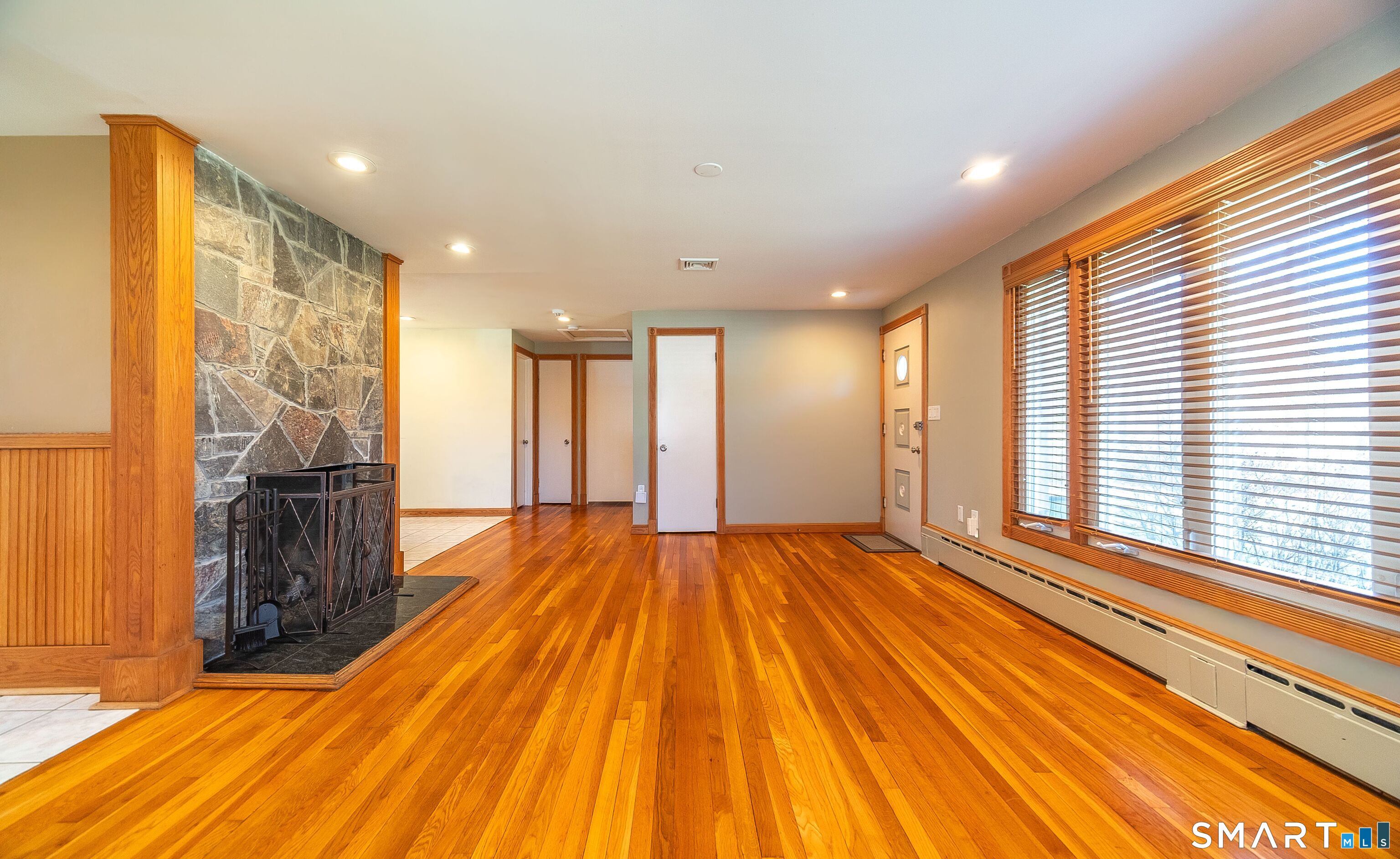 16 Featherbed Lane Branford, CT 06405 - Photo 3 of 40 a view of an empty room with wooden floor and a window
