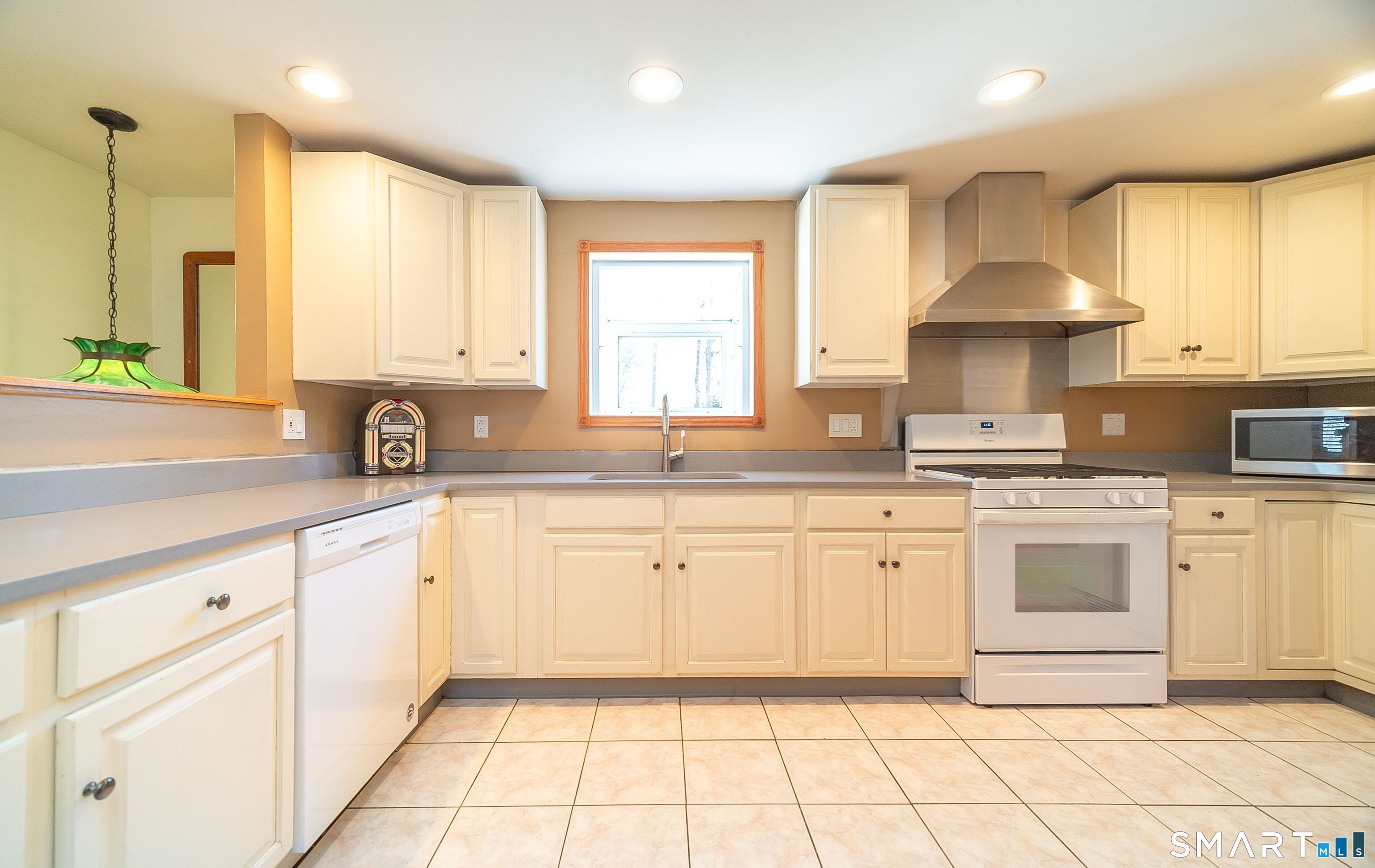16 Featherbed Lane Branford, CT 06405 - Photo 6 of 40 a kitchen with granite countertop white cabinets white appliances a sink and a window
