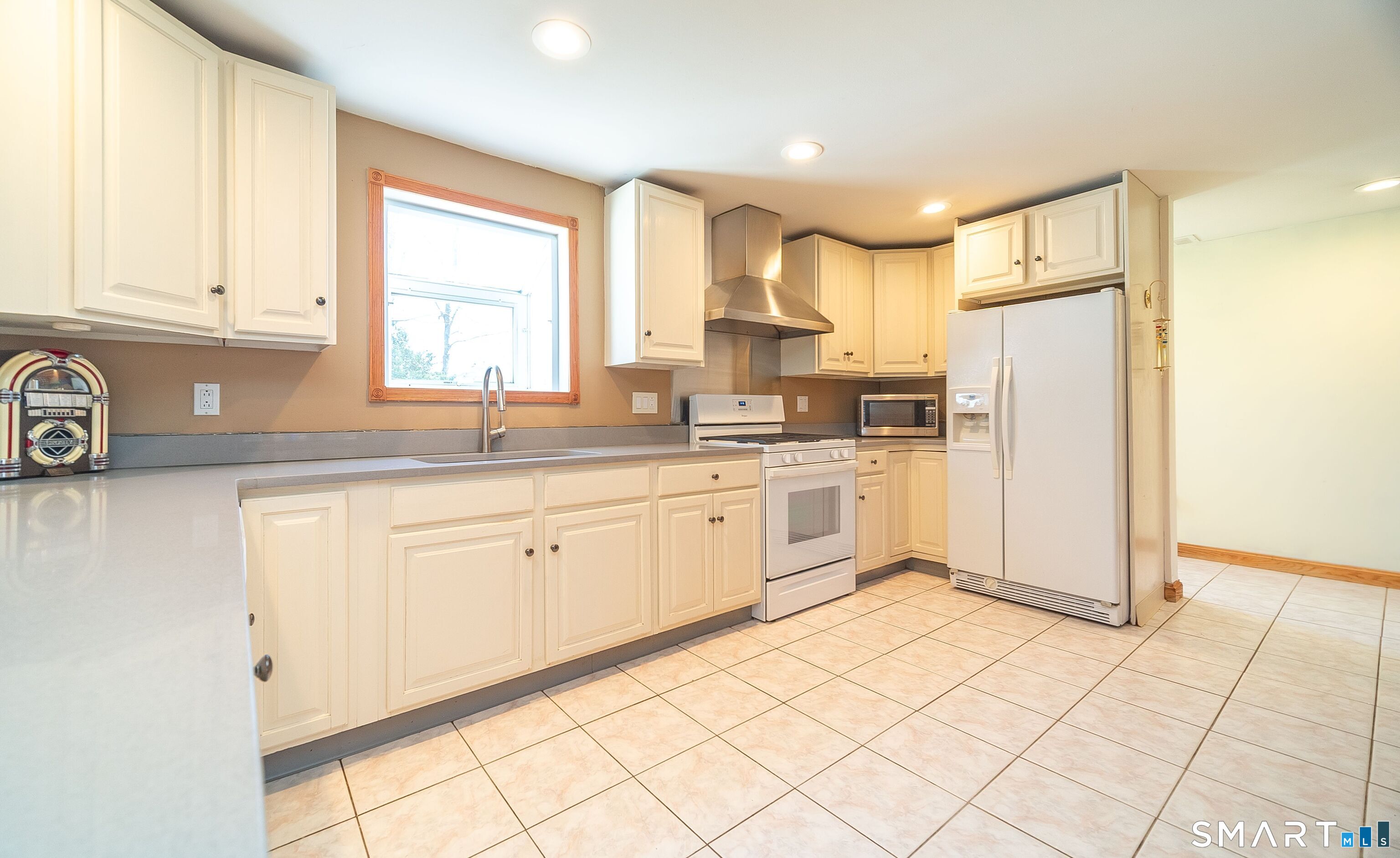 16 Featherbed Lane Branford, CT 06405 - Photo 7 of 40 a kitchen with white cabinets and white appliances