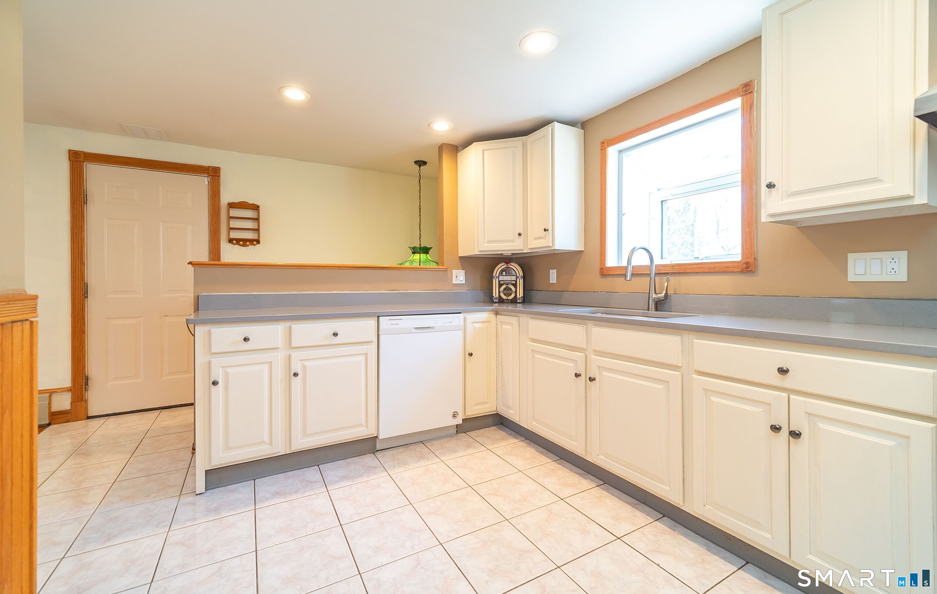 16 Featherbed Lane Branford, CT 06405 - Photo 8 of 40 a kitchen with white cabinets sink and window