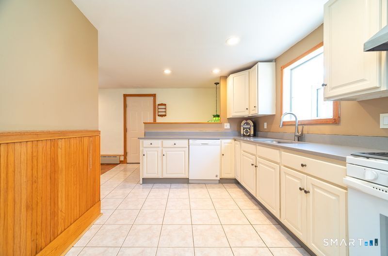 16 Featherbed Lane Branford, CT 06405 - Photo 9 of 40 a large kitchen with a sink window and cabinets