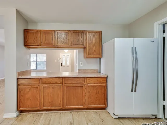 a kitchen with stainless steel appliances granite countertop a refrigerator a sink and dishwasher