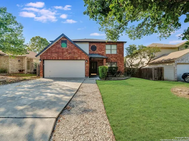 a front view of a house with a garden and yard