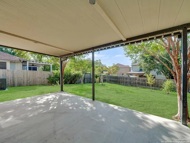 a view of a house with a big yard and potted plants