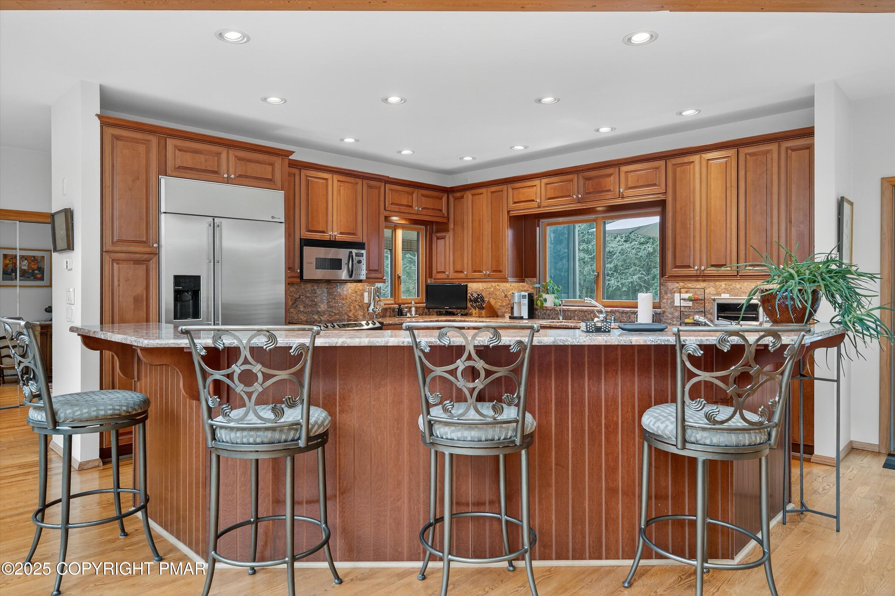804 Ranch Court Hawley, PA 18428 - Photo 11 of 74 a kitchen with stainless steel appliances granite countertop a stove a sink and a dining table