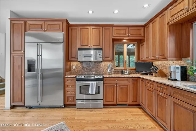 a spacious bedroom with a bed a couch and a window