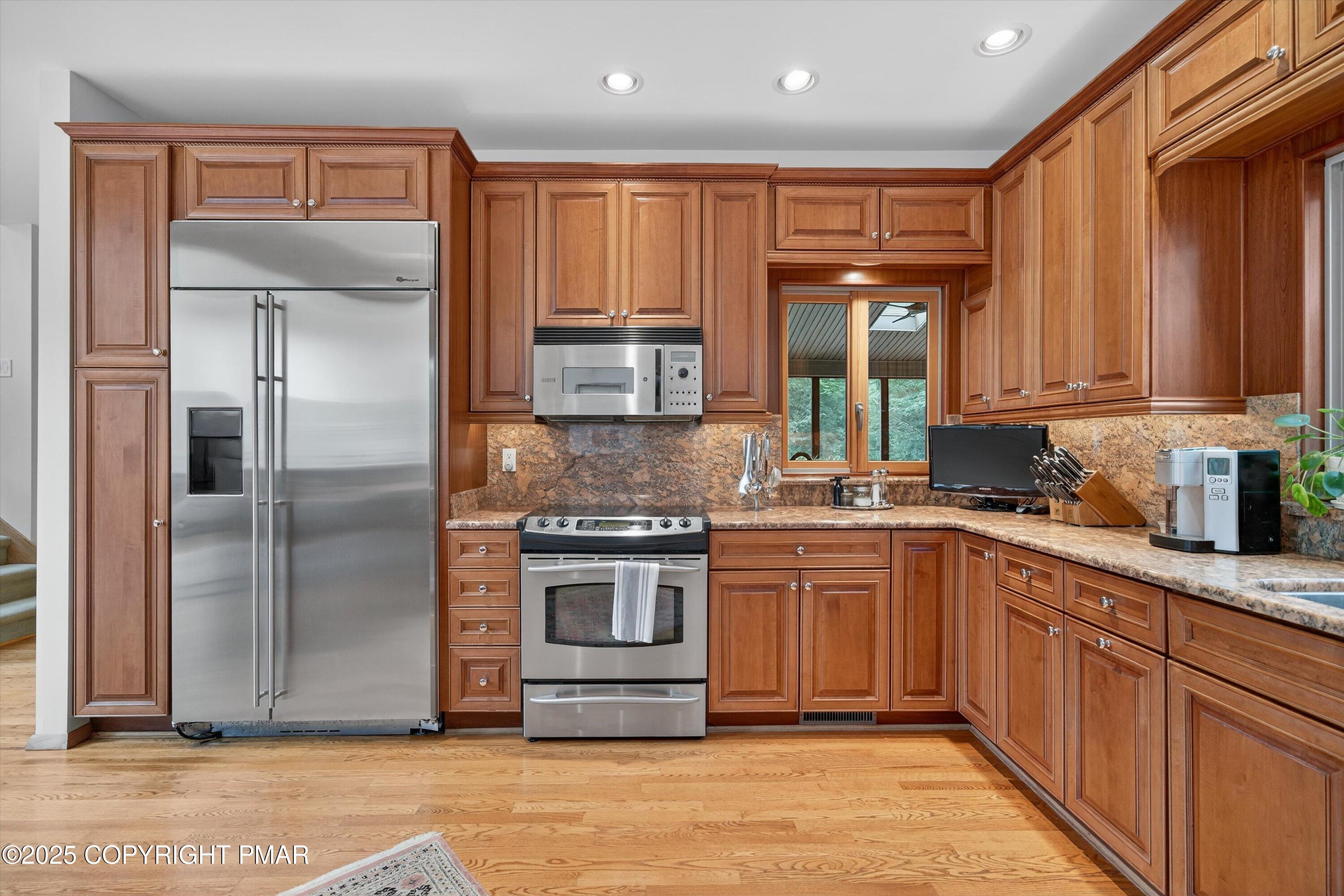 804 Ranch Court Hawley, PA 18428 - Photo 13 of 74 a kitchen with stainless steel appliances granite countertop a refrigerator sink and cabinets