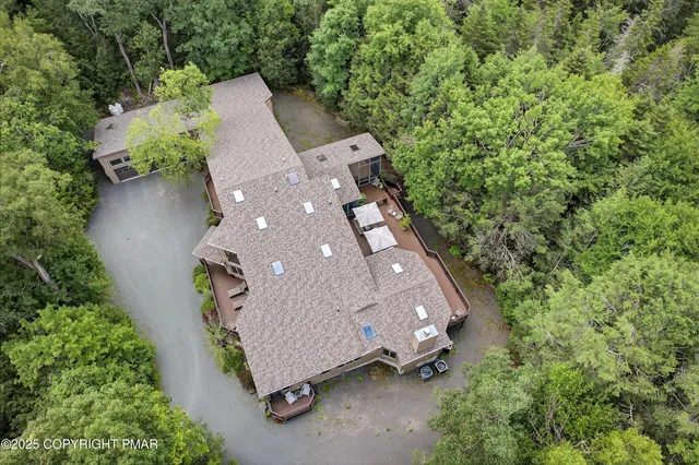 a living room with furniture and a dining table with kitchen view