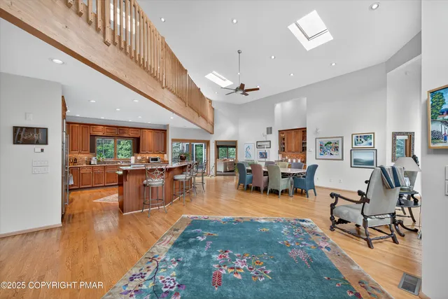 a dining room with furniture a floor to ceiling window and wooden floor