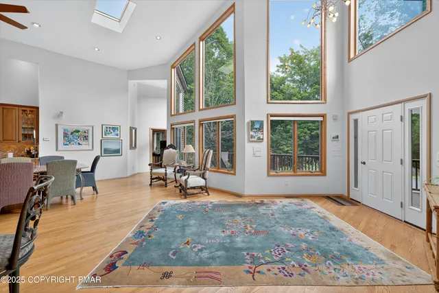 a living room with furniture and large windows