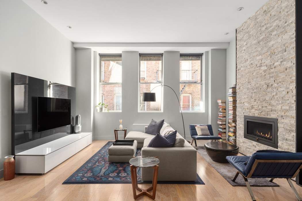 a living room with furniture flat screen tv and a fireplace