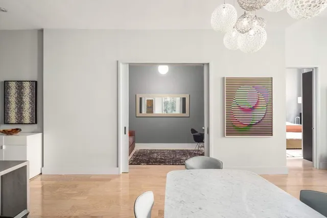 a view of a dining room with furniture and chandelier