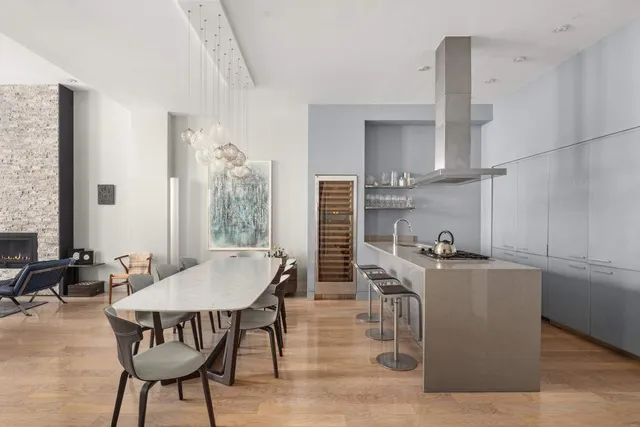 a view of a dining room with furniture and chandelier