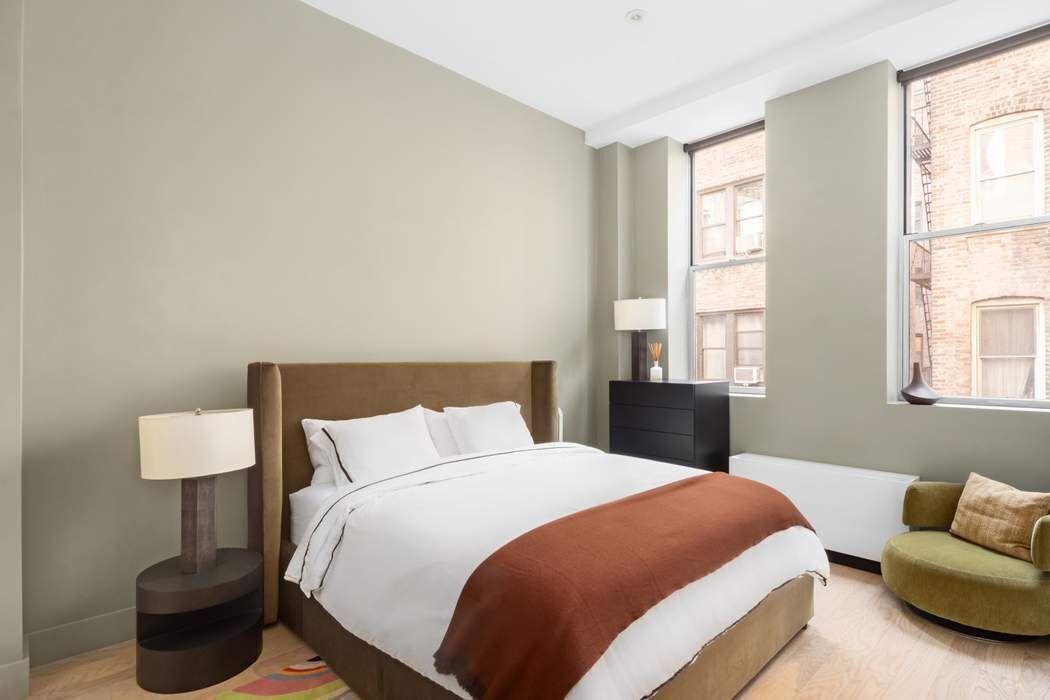 420 West 25th Street, Unit 2E Manhattan, NY 10001 - Photo 7 of 18 a bedroom with a bed and window