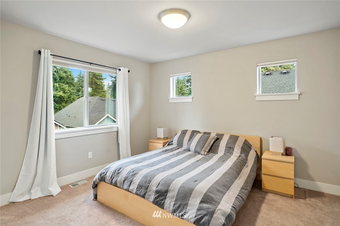 2313 242nd Place Southwest Bothell, WA 98021 - Photo 22 of 27 a bedroom with a bed and a window