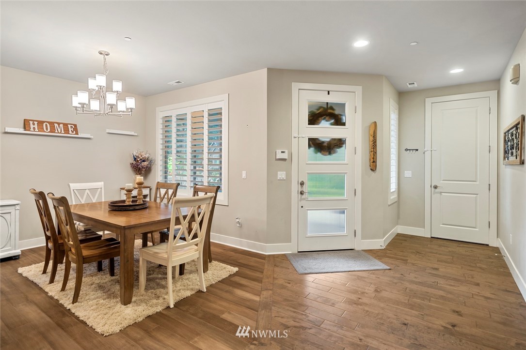 2313 242nd Place Southwest Bothell, WA 98021 - Photo 8 of 27 a view of a dining room with furniture a chandelier and wooden floor