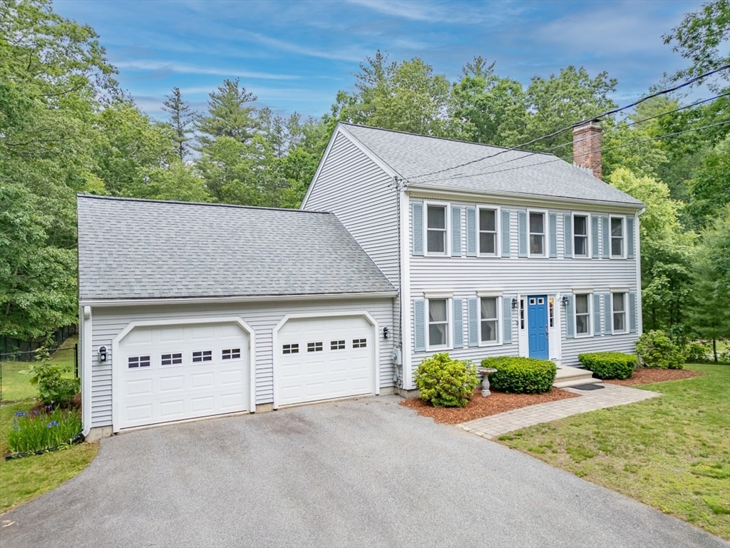 94 Haynes Road Townsend, MA 01469 - Photo 23 of 34 a front view of a house with a yard and garage