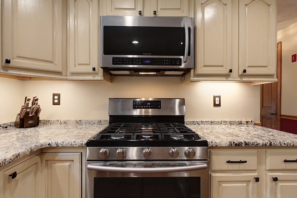 94 Haynes Road Townsend, MA 01469 - Photo 5 of 34 a kitchen with granite countertop a stove and a sink