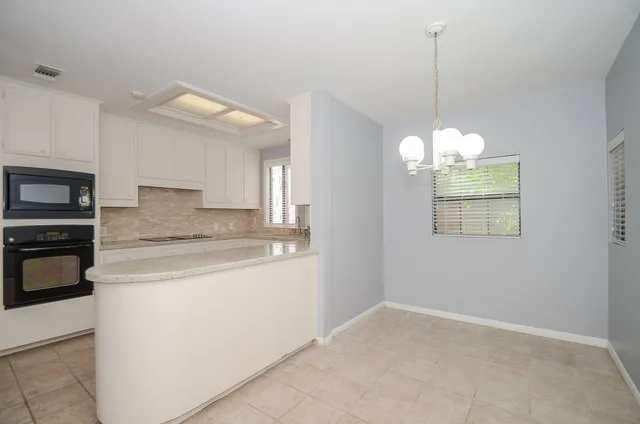 a view of a kitchen sink and microwave