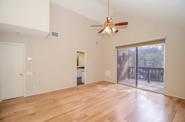a view of a room with wooden floor
