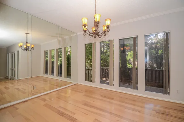 a view of an empty room with a chandelier