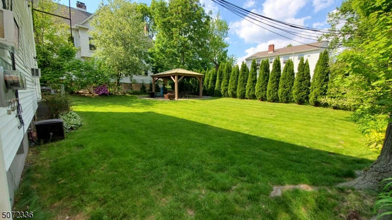 42 Walnut Street, Unit 1 Montclair, NJ 07042 - Photo 2 of 11 a view of a big yard with potted plants and large trees
