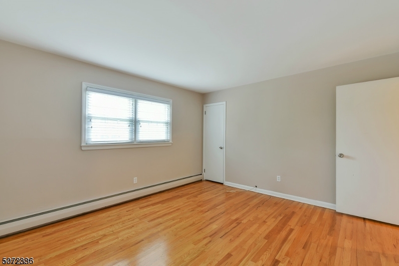 42 Walnut Street, Unit 1 Montclair, NJ 07042 - Photo 9 of 11 an empty room with wooden floor and windows